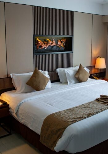 white bed linen with throw pillows